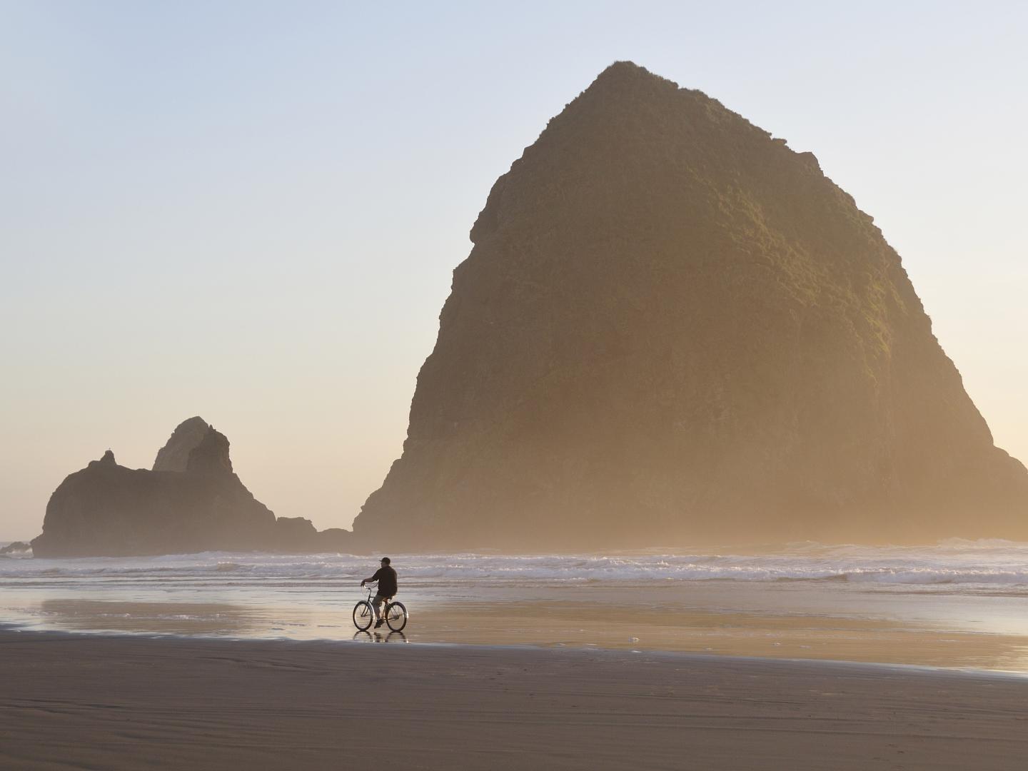Cycling on Cannon Beach in front of Haystack Rock Cycling on Cannon Beach in front of Haystack Rock