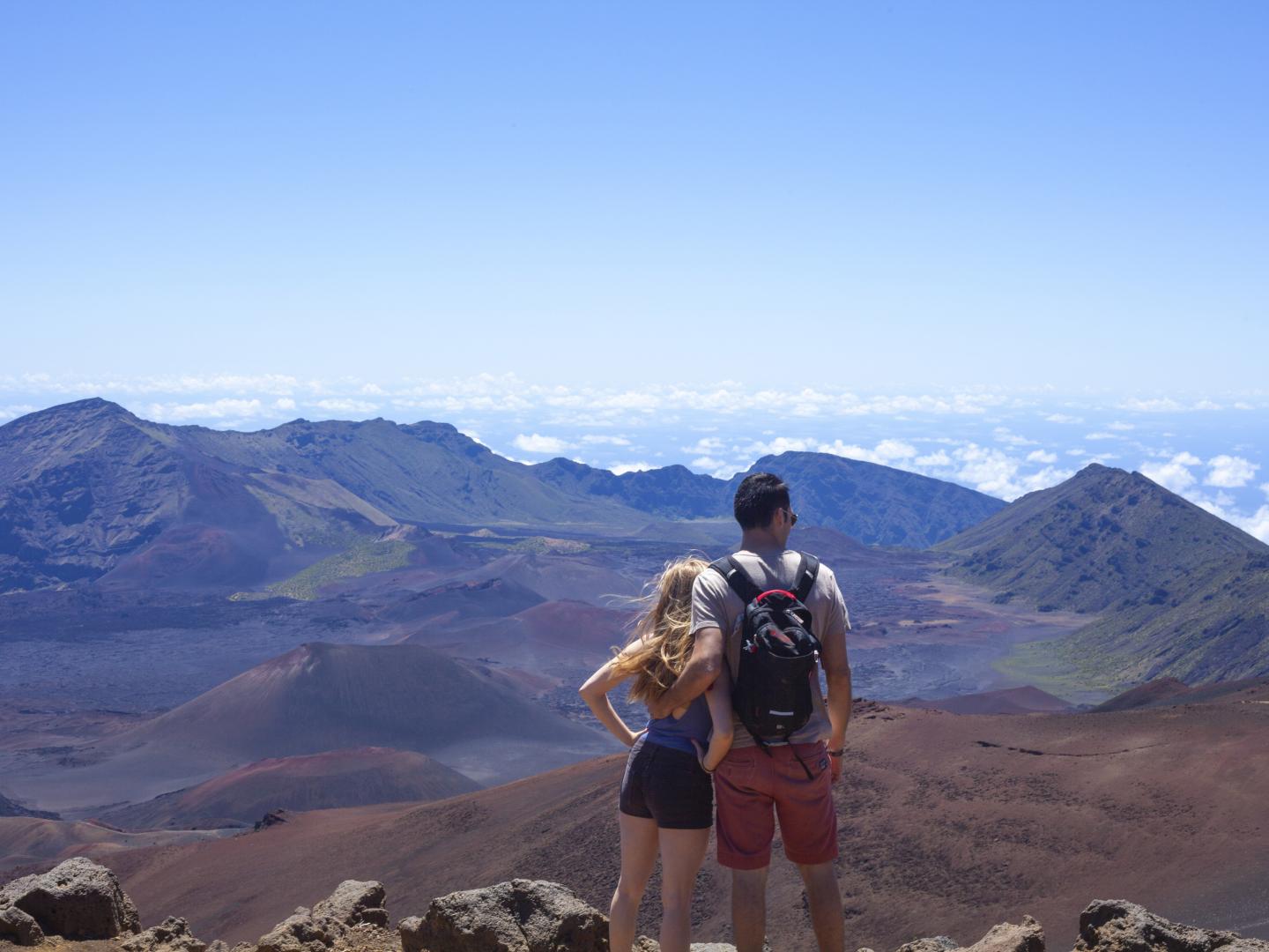 Couple taking in views of Haleakalā National Park in Maui, Hawaiʻi Couple taking in views of Haleakalā National Park in Maui, Hawaiʻi