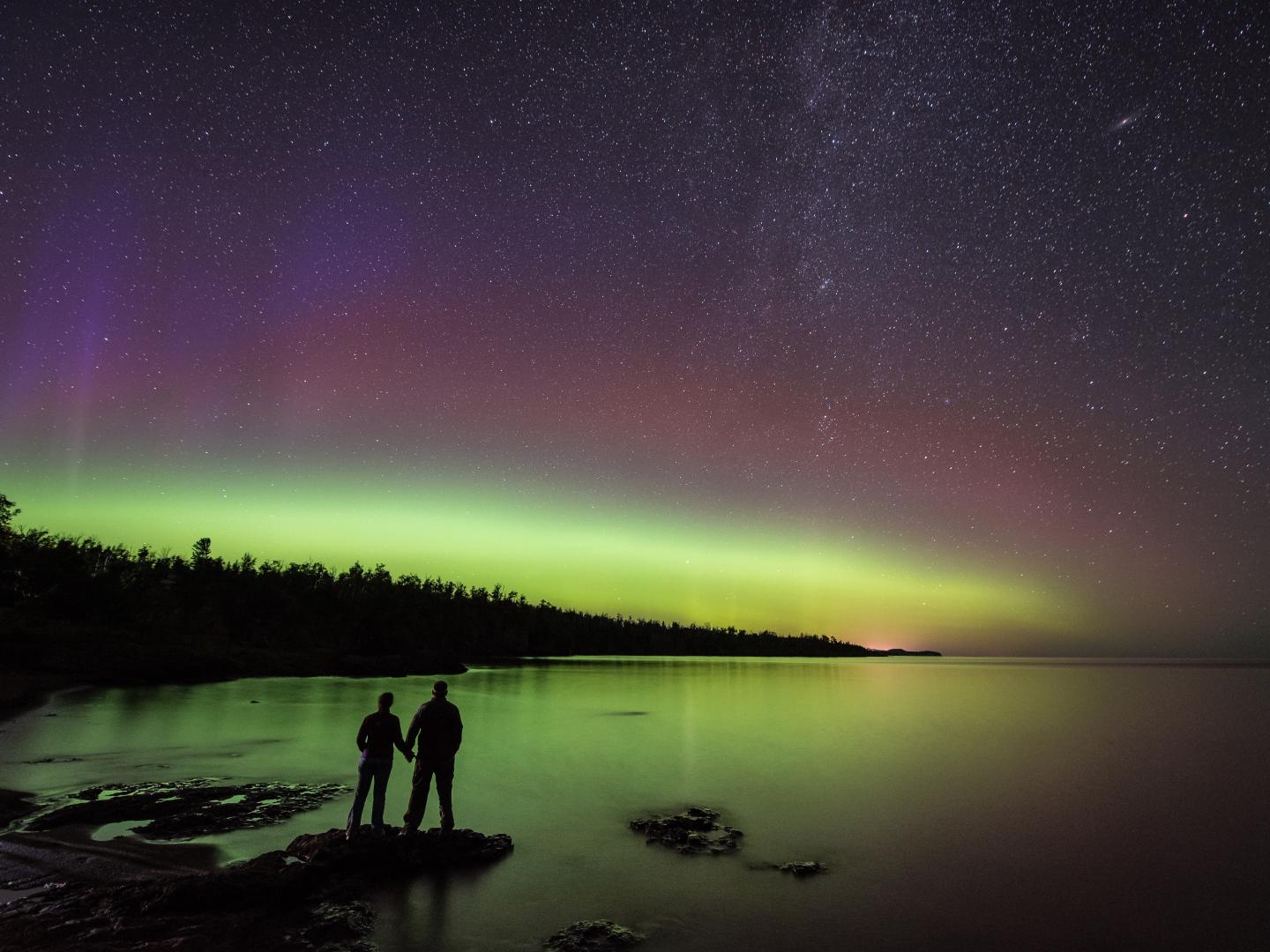 Couple watching the northern lights from Gooseberry Falls State Park on the North Shore of Lake Superior Couple watching the northern lights from Gooseberry Falls State Park on the North Shore of Lake Superior