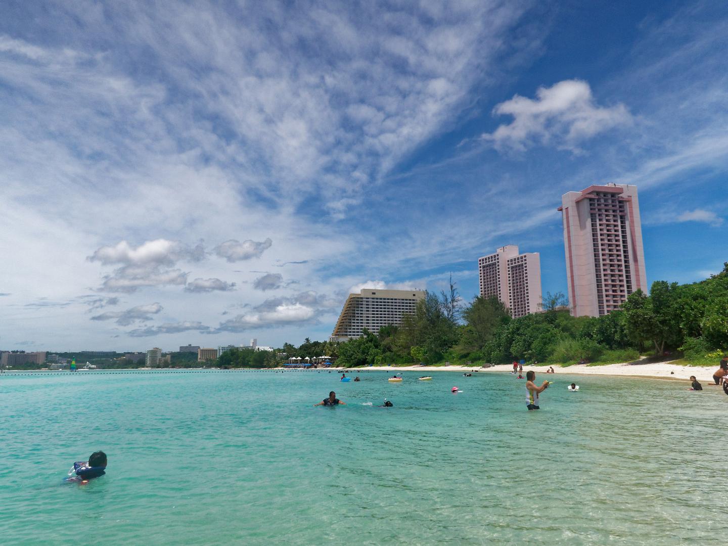 Beachgoers playing in the surf at Ypao Beach in Guam Beachgoers playing in the surf at Ypao Beach in Guam