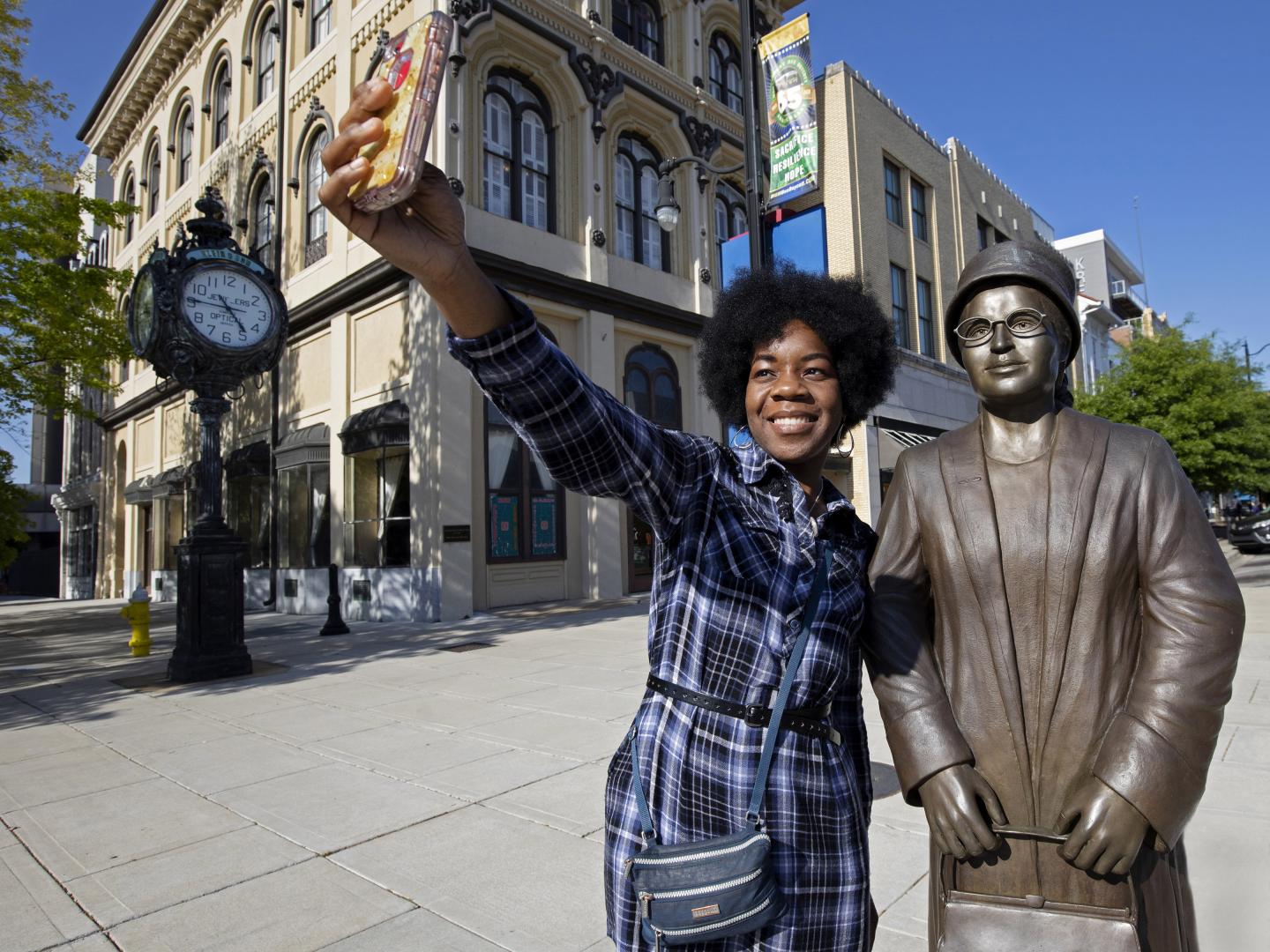 Woman posing with a bronze statue of Rosa Parks in Montgomery, Alabama Woman posing with a bronze statue of Rosa Parks in Montgomery, Alabama