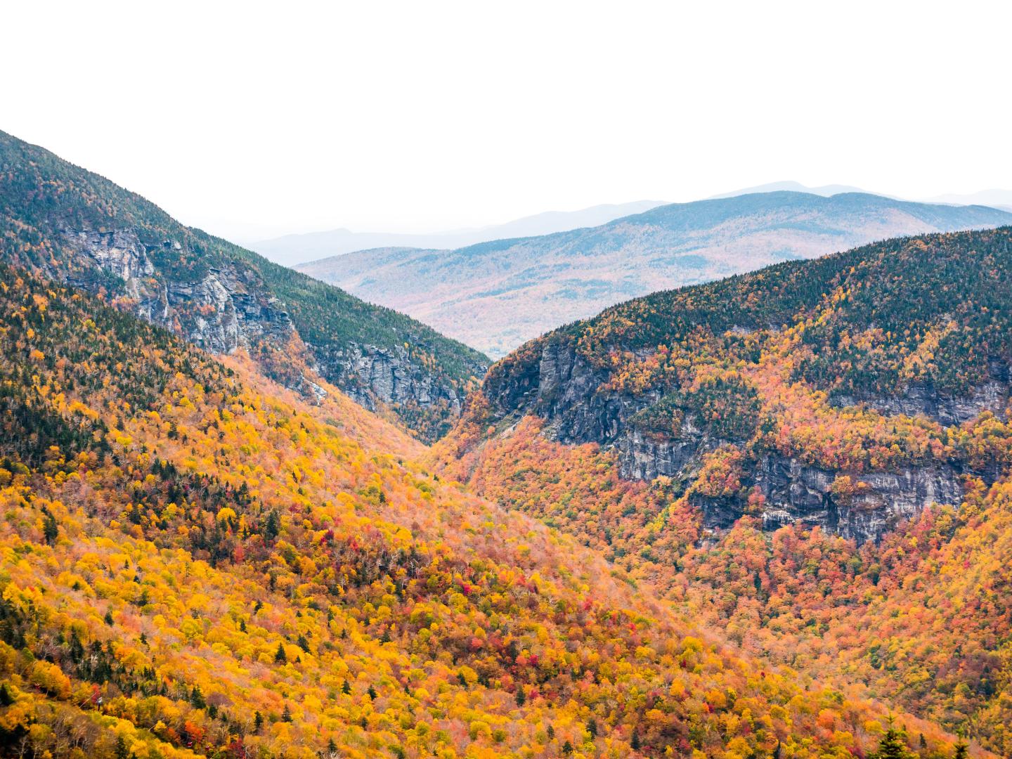 Fall foliage and sheer rock faces on the mountains of Smugglers’ Notch State Park in Vermont Fall foliage and sheer rock faces on the mountains of Smugglers’ Notch State Park in Vermont