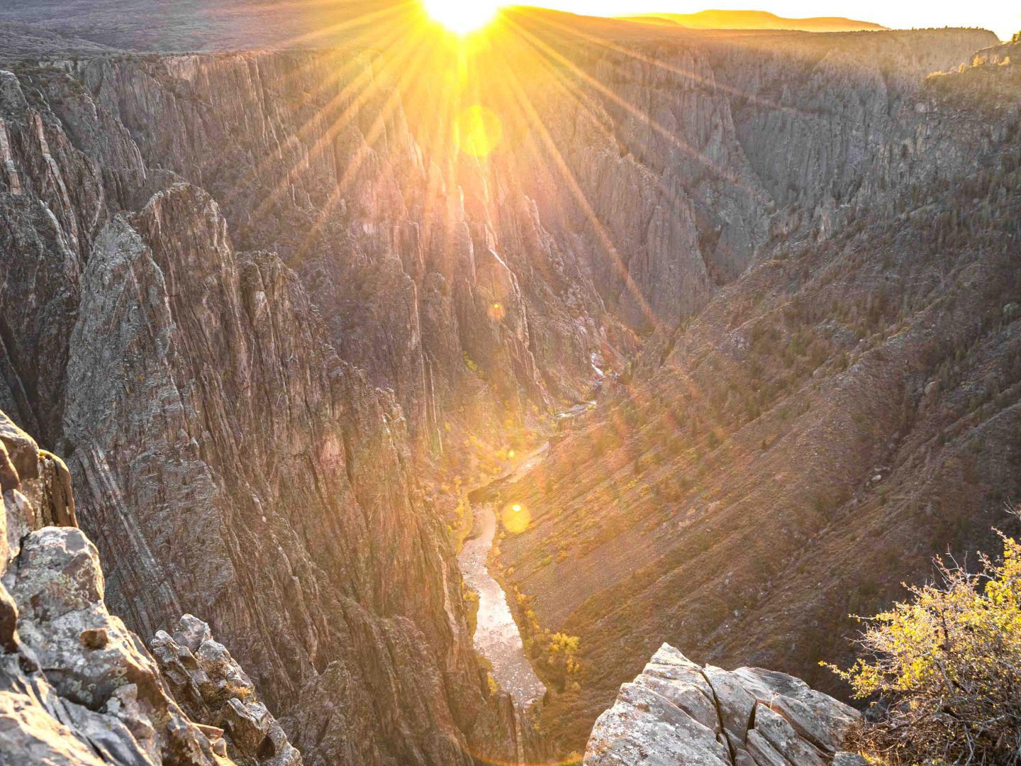 The sun shining over Black Canyon of the Gunnison National Park in Colorado The sun shining over Black Canyon of the Gunnison National Park in Colorado