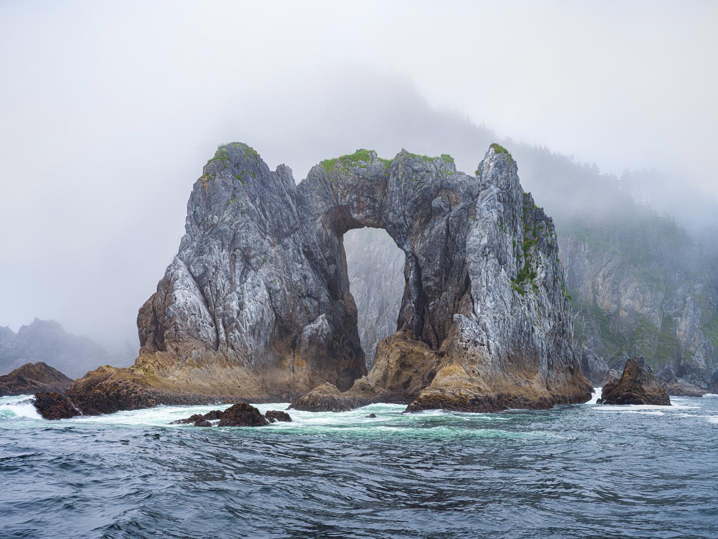 Mist surrounds the striking rock formations of Kenai Fjords National Park in Alaska Mist surrounds the striking rock formations of Kenai Fjords National Park in Alaska