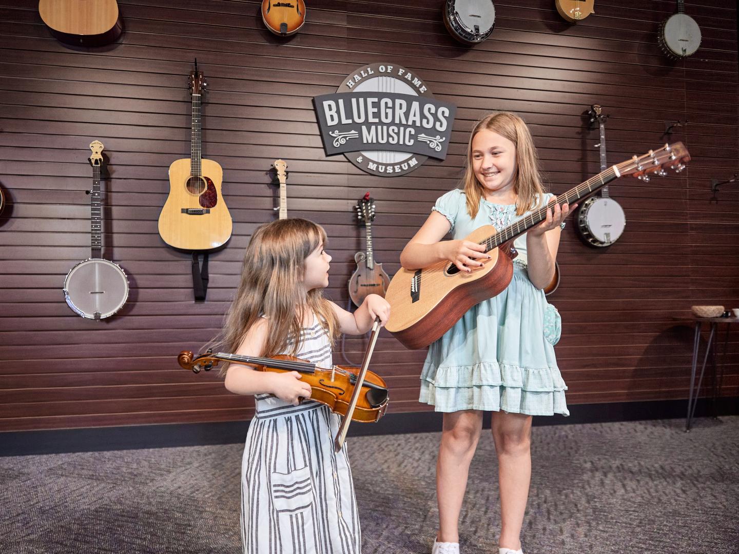 Playing musical instruments in an exhibit at the Bluegrass Music Hall of Fame & Museum in Owensboro, Kentucky Playing musical instruments in an exhibit at the Bluegrass Music Hall of Fame & Museum in Owensboro, Kentucky