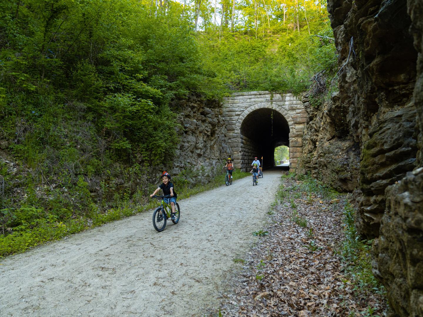 Family cycling down a path in Katy Trail State Park in Missouri Family cycling down a path in Katy Trail State Park in Missouri