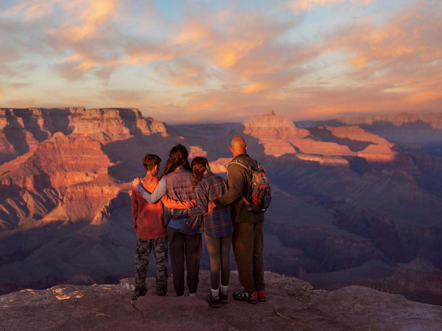 A family admires the Grand Canyon from an overlook in Grand Canyon National Park, Arizona A family admires the Grand Canyon from an overlook in Grand Canyon National Park, Arizona