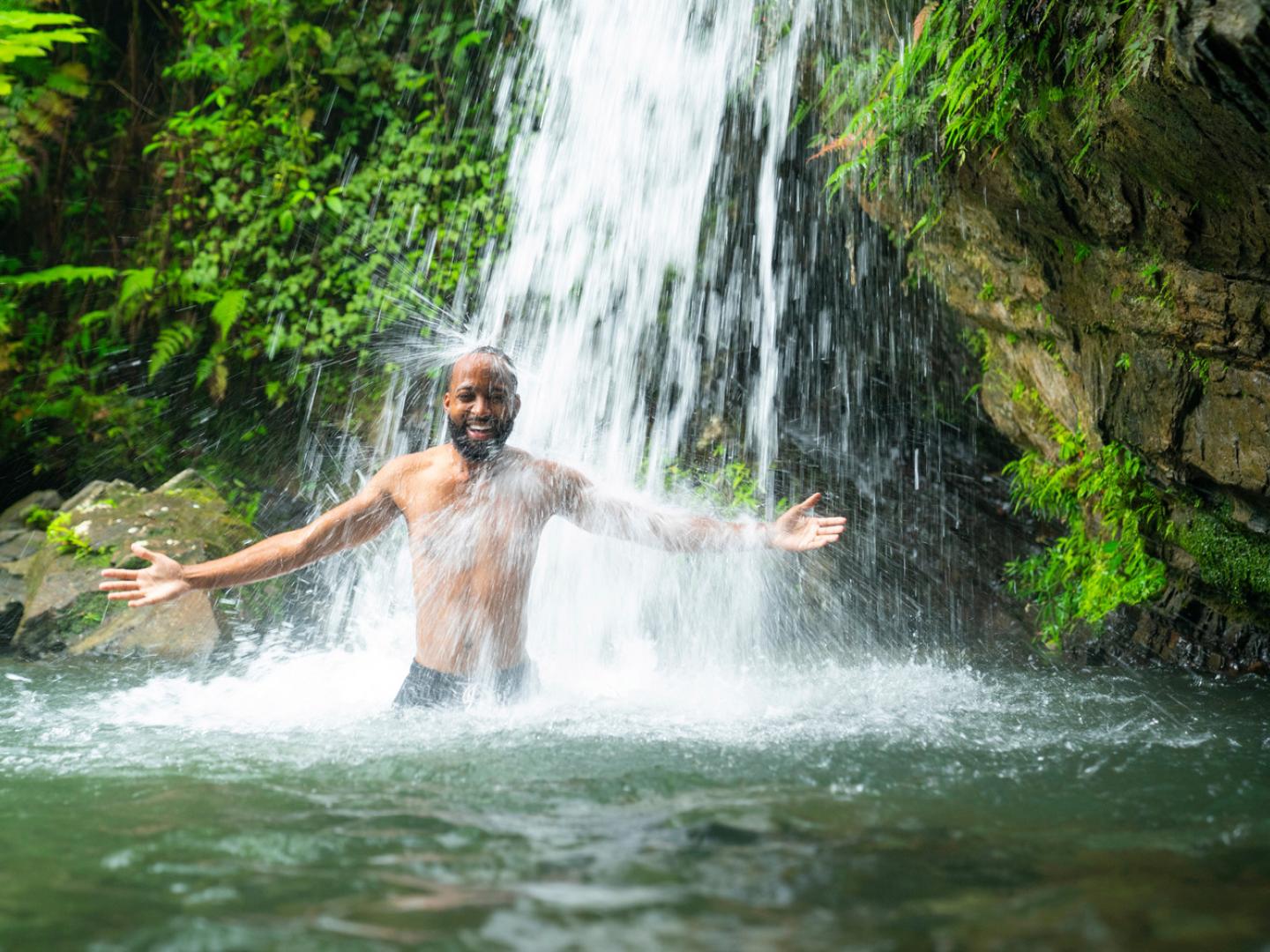 Wading beneath a waterfall in Puerto Rico’s El Yunque National Forest Wading beneath a waterfall in Puerto Rico’s El Yunque National Forest