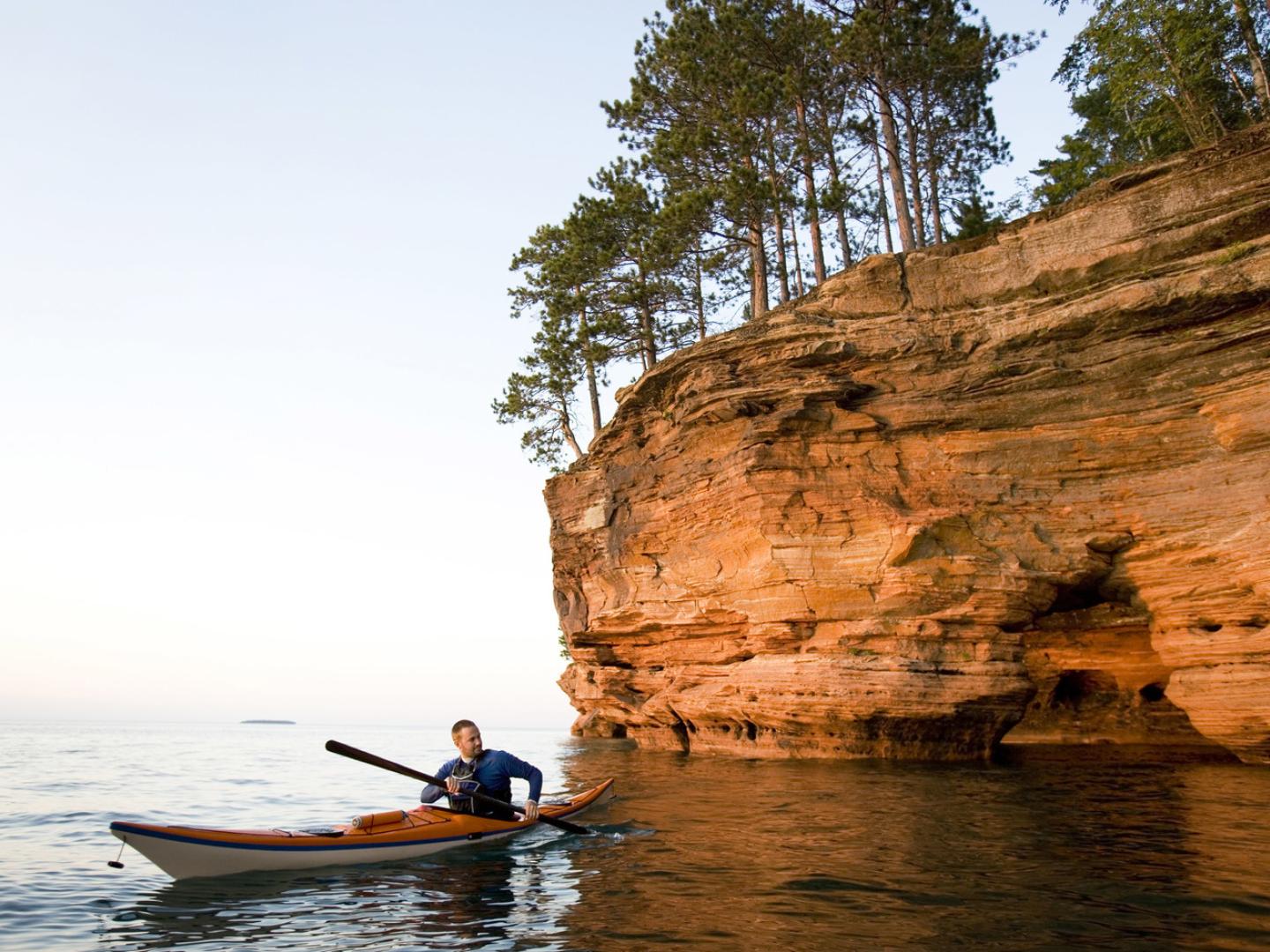 Kayaking around striking sea caves at Apostle Islands National Lakeshore in Wisconsin Kayaking around striking sea caves at Apostle Islands National Lakeshore in Wisconsin