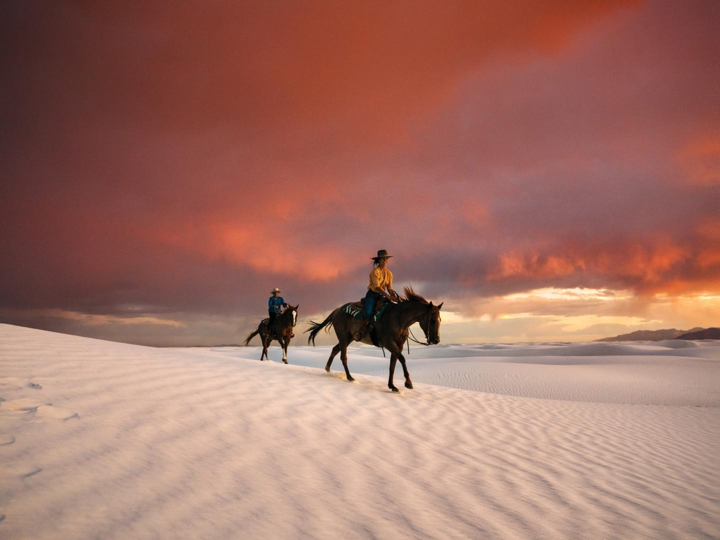 Riding horses through White Sands National Park near Alamogordo, New Mexico Riding horses through White Sands National Park near Alamogordo, New Mexico