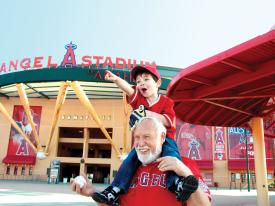 Grandfather and grandson outside the Angels baseball stadium in Anaheim, California