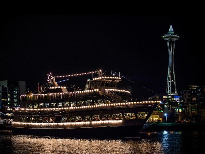A decked-out ship floating in front of the Space Needle during Argosy Christmas Ships & Bonfires A decked-out ship floating in front of the Space Needle during Argosy Christmas Ships & Bonfires