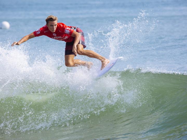 A surfer competes in the Coastal Edge East Coast Surfing Championships in Virginia Beach, Virginia A surfer competes in the Coastal Edge East Coast Surfing Championships in Virginia Beach, Virginia