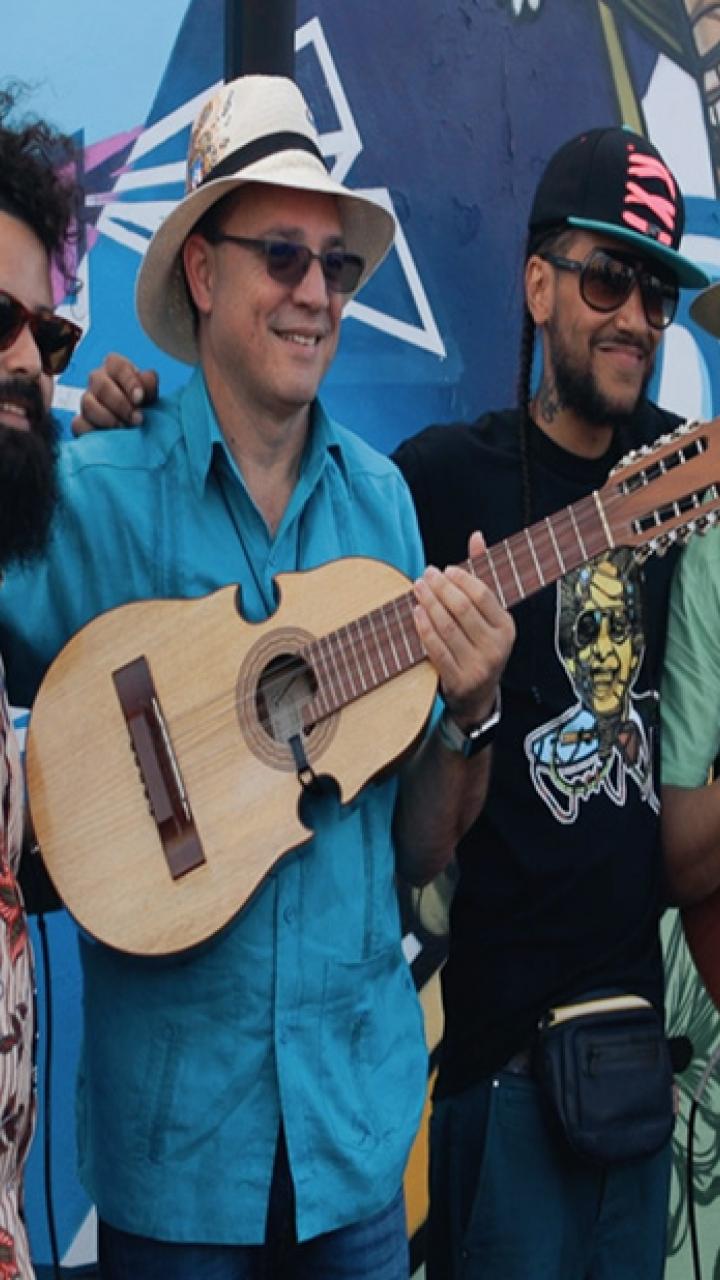 Street artists and musicians posing in front of a Miami, Florida, mural