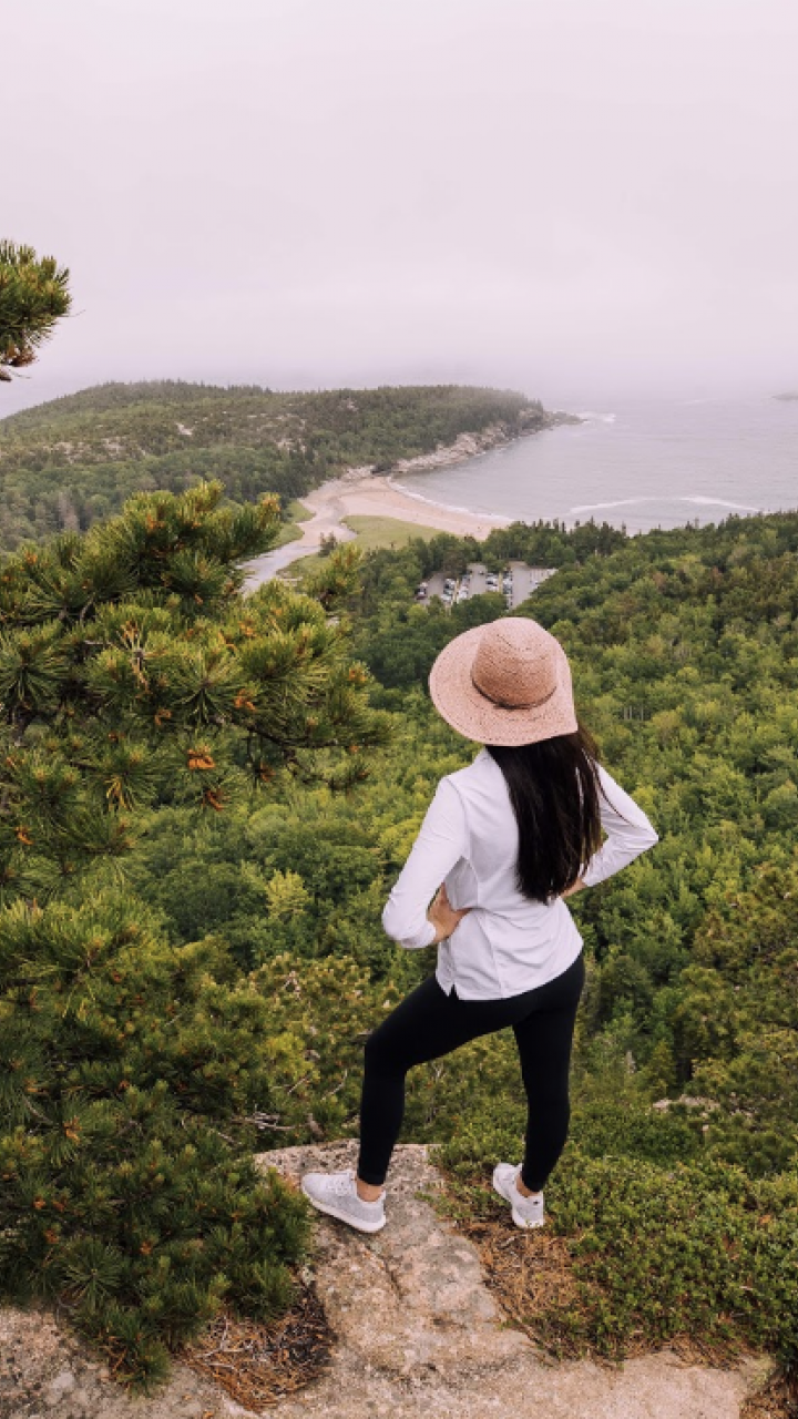 A hiker overlooking the coast of Maine