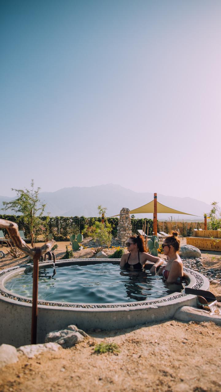 Soaking it a hot tub surrounded by desert landscapes near Palm Springs, California