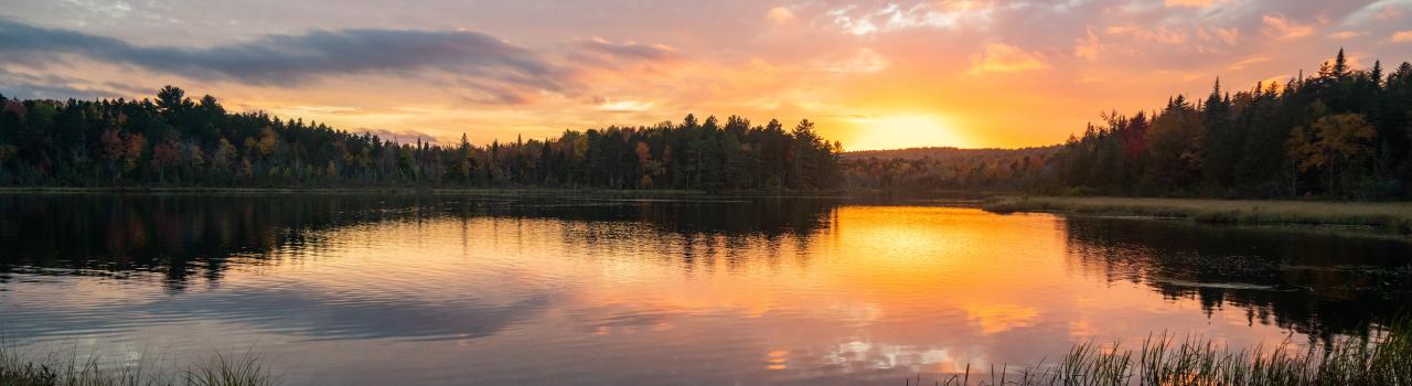 Sunset over a mountain lake in Millinocket, Maine Sunset over a mountain lake in Millinocket, Maine