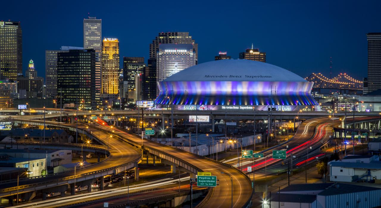 The Mercedes-Benz Superdome arena, gleaming in the night sky of New Orleans, Louisiana The Mercedes-Benz Superdome arena, gleaming in the night sky of New Orleans, Louisiana