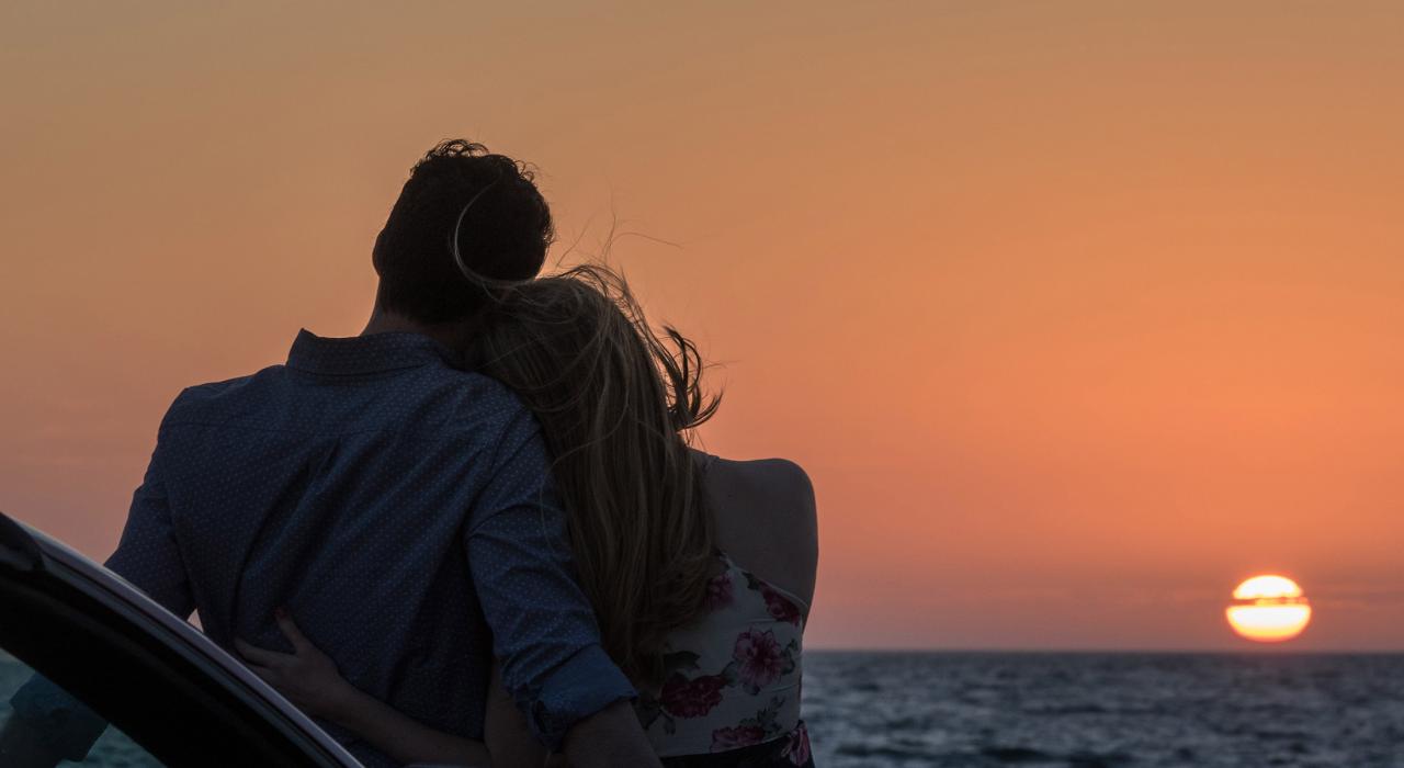 Couple on a road trip taking in the sunset from the Skyway Fishing Pier State Park near St. Petersburg, Florida Couple on a road trip taking in the sunset from the Skyway Fishing Pier State Park near St. Petersburg, Florida