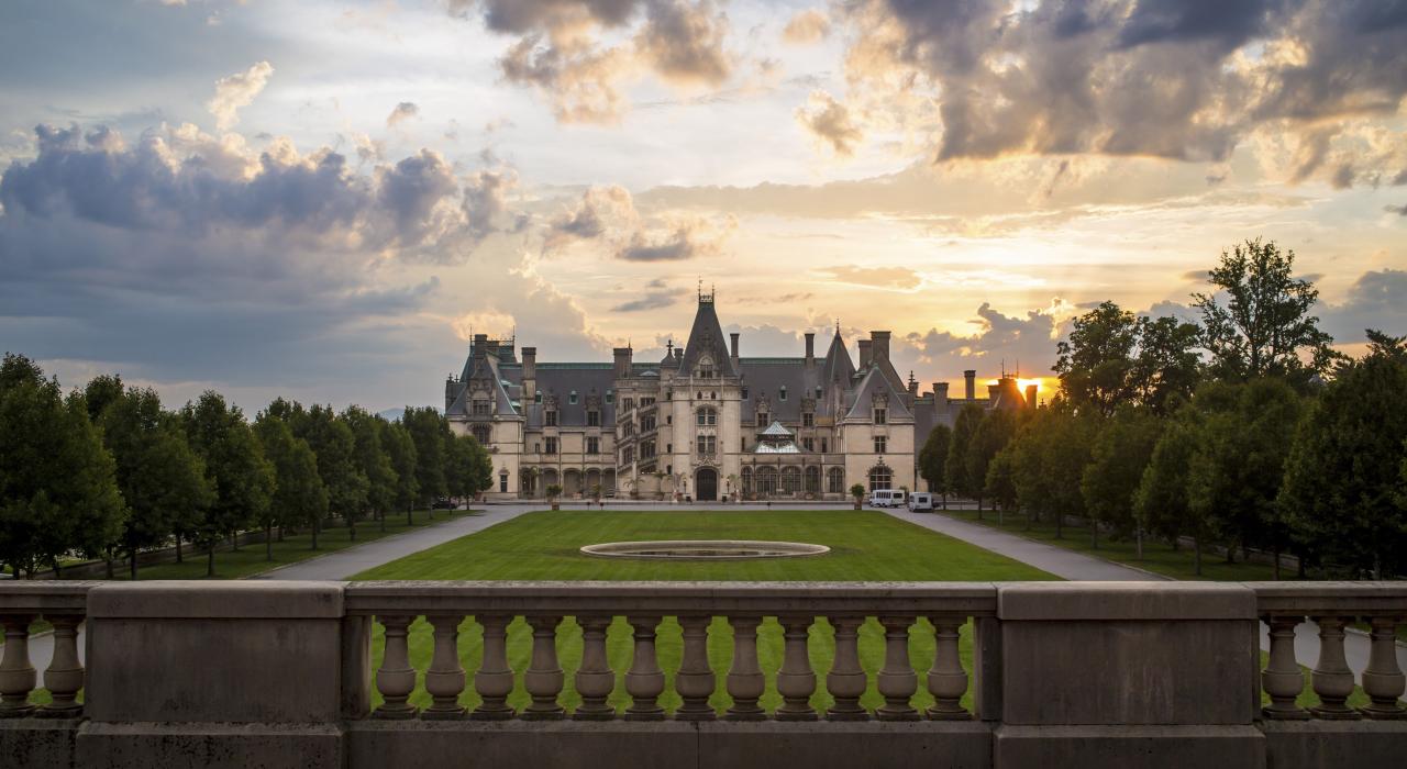 The sun setting behind the Biltmore mansion in Asheville, North Carolina The sun setting behind the Biltmore mansion in Asheville, North Carolina