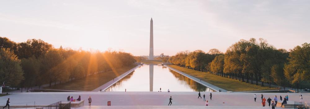 Sun shining over the National Mall with the Washington Monument in the background in Washington D.C.