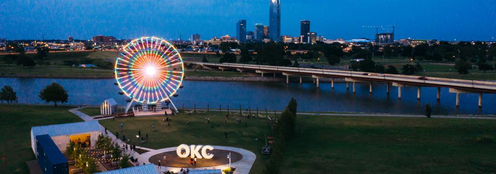 Lights of the Wheeler Ferris Wheel overlooking the Oklahoma River and downtown Oklahoma City