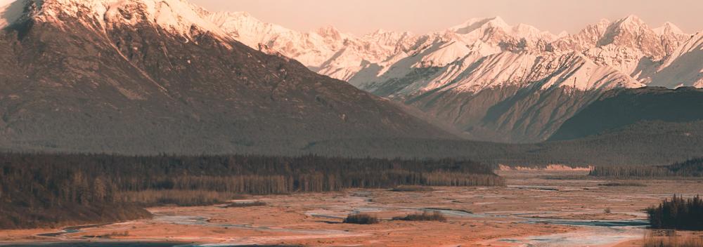 Sunlit, snow-capped mountains in Alaska