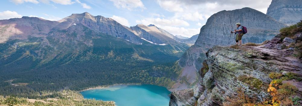 Hiker overlooking Grinnell Lake in Glacier National Park, Montana