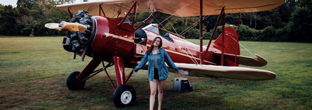 Posing with a biplane at Cape Cod Airfield in Massachusetts