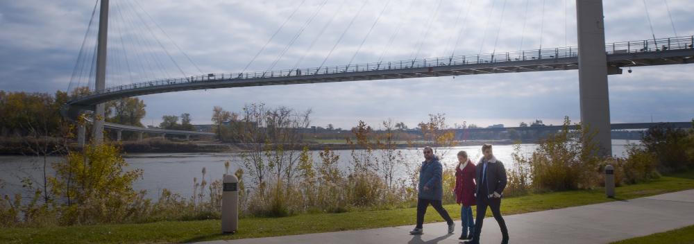 Strolling alongside the Missouri River near the Bob Kerrey Pedestrian Bridge in Omaha, Nebraska