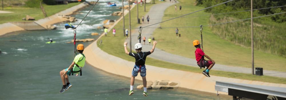 Zip lining with views of the rapids at the U.S. National Whitewater Center in Charlotte, North Carolina